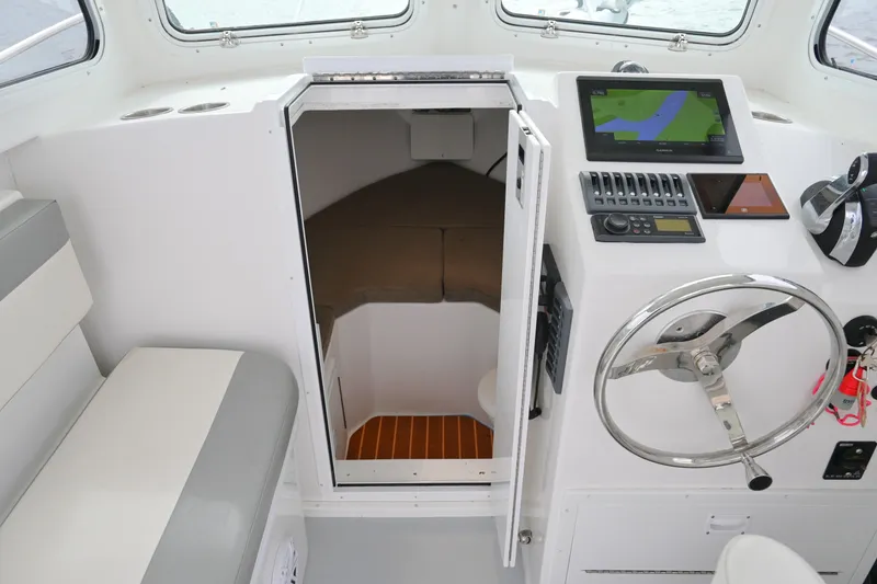 Slide: The Image of 2022 Steiger Craft 255DV Miami boat interior with helm, seating, and cabin entrance. - 31