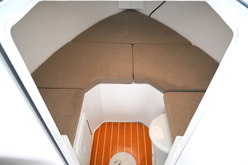 Slide: The Image of 2022 Steiger Craft 255DV Miami cabin interior with cushioned seating and wooden flooring. - 32