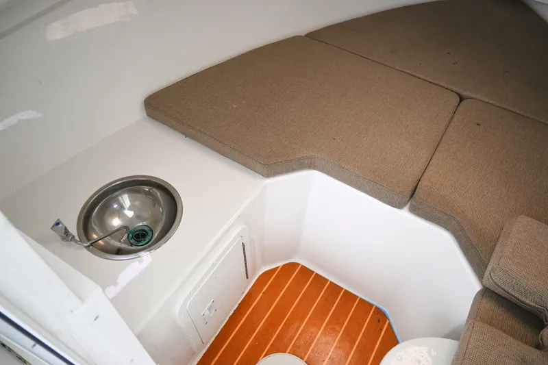 Slide: The Image of 2022 Steiger Craft 255DV Miami cabin interior with sink and cushioned seating. - 33