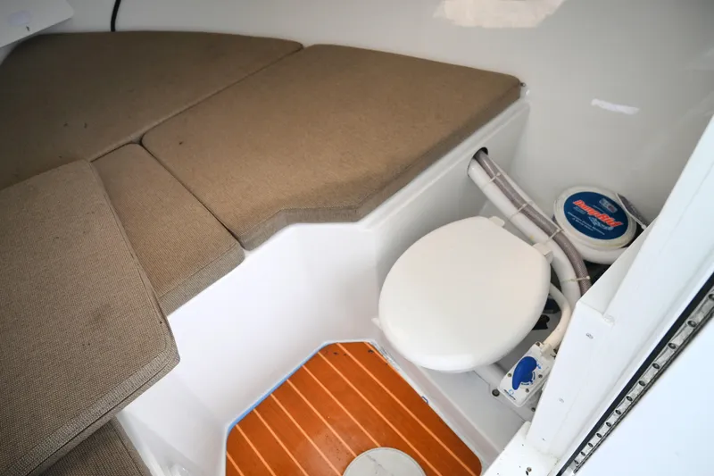Slide: The Image of 2022 Steiger Craft 255DV Miami cabin interior with toilet and cushioned seating. - 34