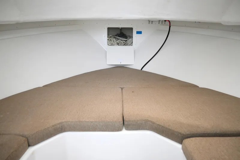 Slide: The Image of 2022 Steiger Craft 255DV Miami cabin interior with cushioned seating and storage compartment. - 35