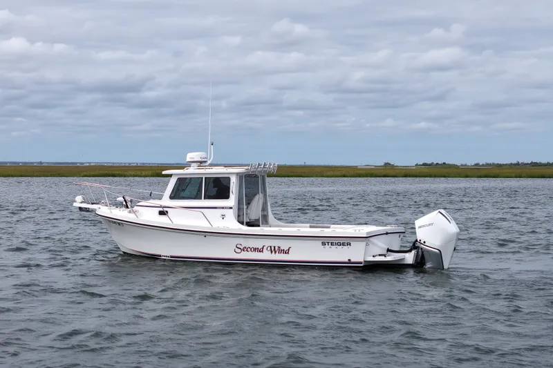 Slide: The Image of 2022 Steiger Craft 255DV Miami boat on water, overcast sky, side view. - 5