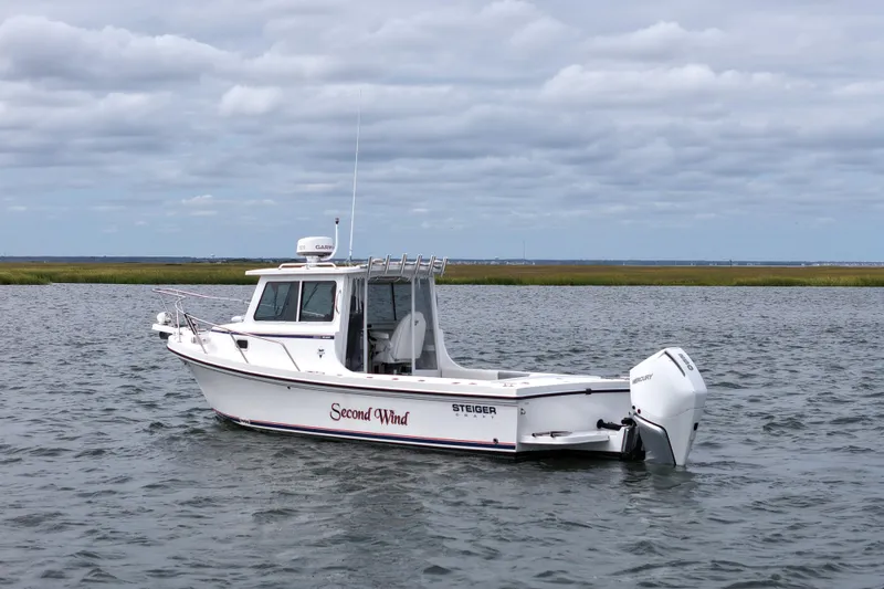 Slide: The Image of 2022 Steiger Craft 255DV Miami boat on water under cloudy sky. - 6
