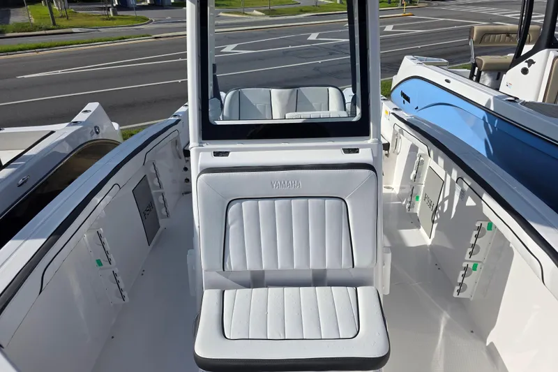 Slide: The Image of 2025 Yamaha Boats 252 FSH Sport interior with seating and storage compartments. - 13