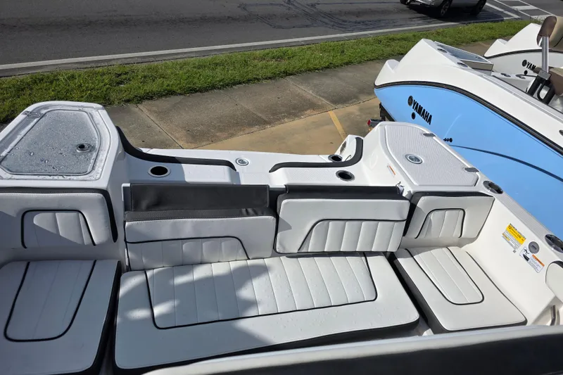 Slide: The Image of 2025 Yamaha Boats 252 FSH Sport interior seating, featuring sleek white and gray upholstery. - 6