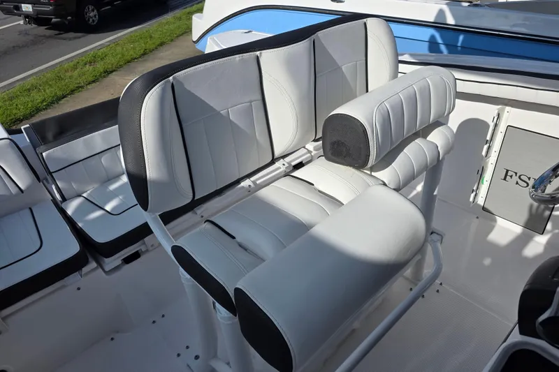 Slide: The Image of 2025 Yamaha Boats 252 FSH Sport interior seating with white and black upholstery. - 7