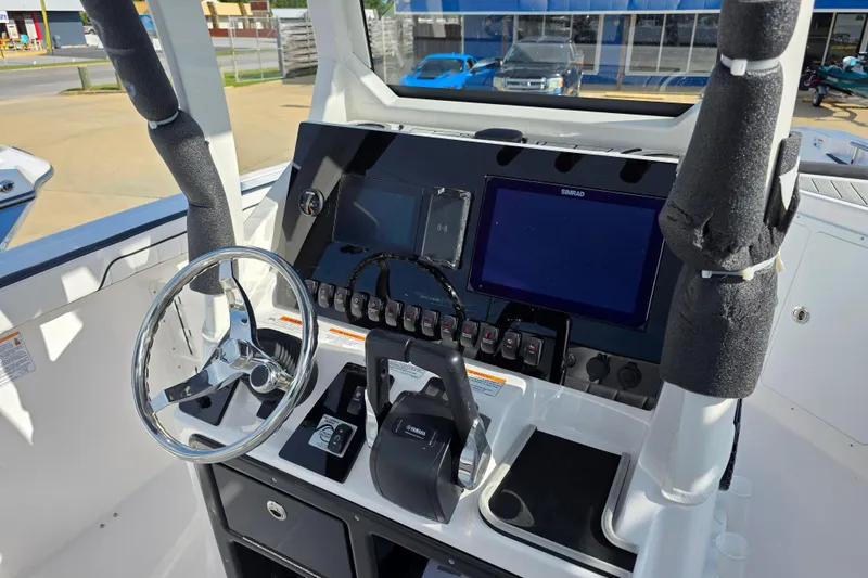 Slide: The Image of 2025 Yamaha Boats 252 FSH Sport dashboard with steering wheel and navigation controls. - 9