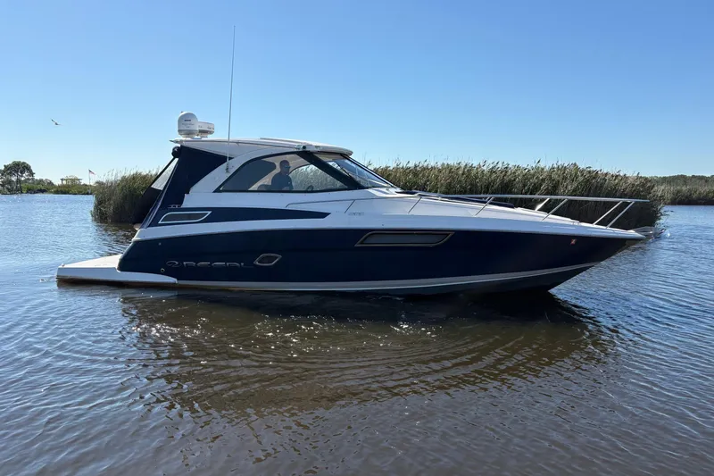 Slide: The Image of 2013 Regal 35 Sport Coupe boat propellers on dry dock, supported by stands. - 11