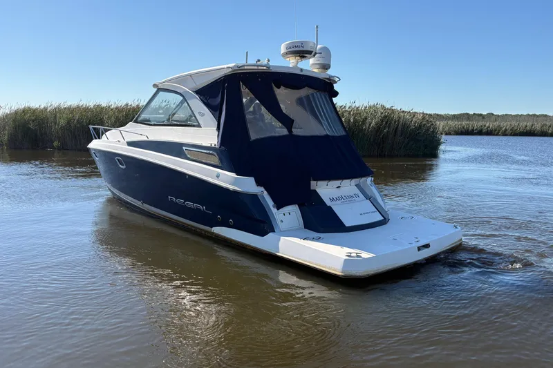 Slide: The Image of 2013 Regal 35 Sport Coupe helm with Garmin navigation, luxurious seating, and sleek interior design. - 15