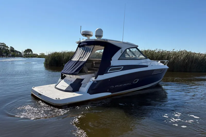 Slide: The Image of 2013 Regal 35 Sport Coupe helm with Garmin navigation and modern controls. - 16