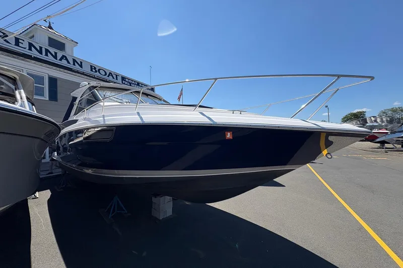 Slide: The Image of 2013 Regal 35 Sport Coupe interior with beige seating and wood flooring. - 18