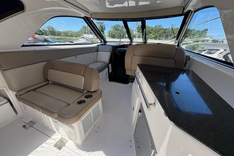 Slide: The Image of 2013 Regal 35 Sport Coupe bathroom with toilet, sink, and showerhead. - 23