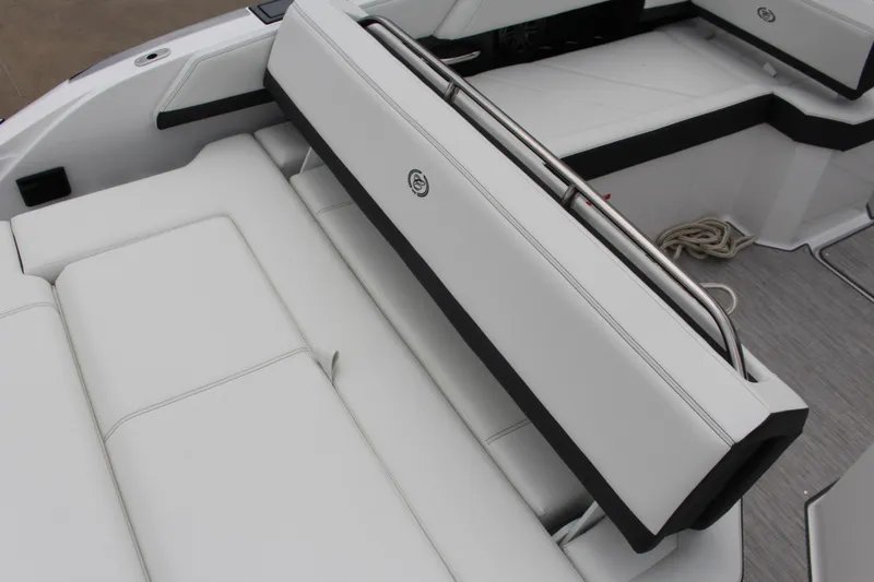 Slide: The Image of 2025 Cobalt R6 boat interior with white cushioned seating and stainless steel rail. - 10