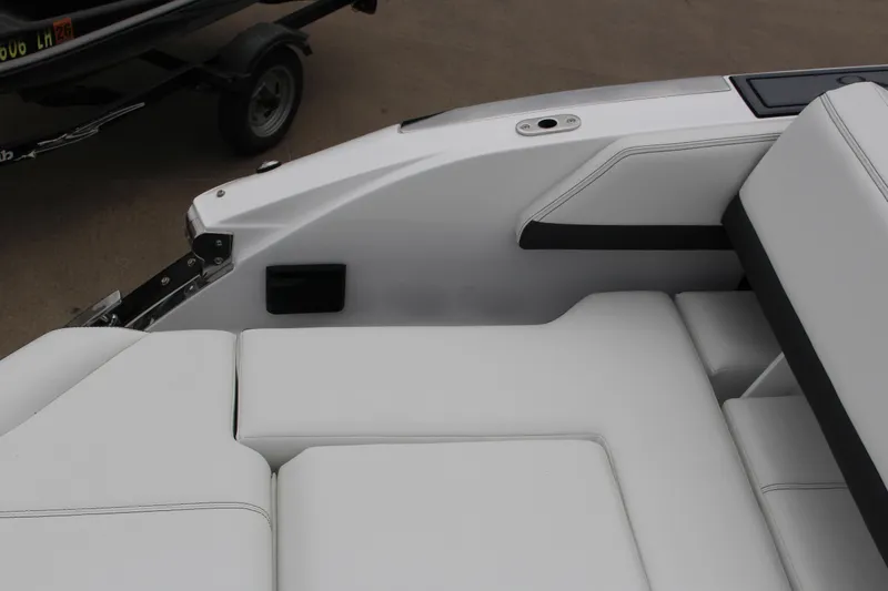 Slide: The Image of 2025 Cobalt R6 boat interior with white cushioned seating and sleek design. - 12