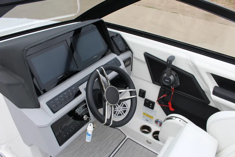 Slide: The Image of 2025 Cobalt R6 boat dashboard with dual screens and modern steering wheel design. - 14