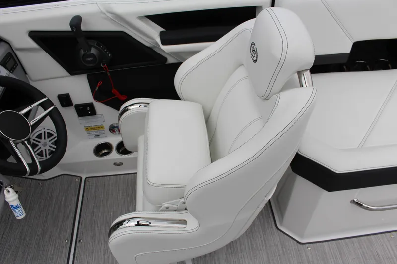 Slide: The Image of 2025 Cobalt R6 boat interior with white captain's chair and steering wheel. - 15