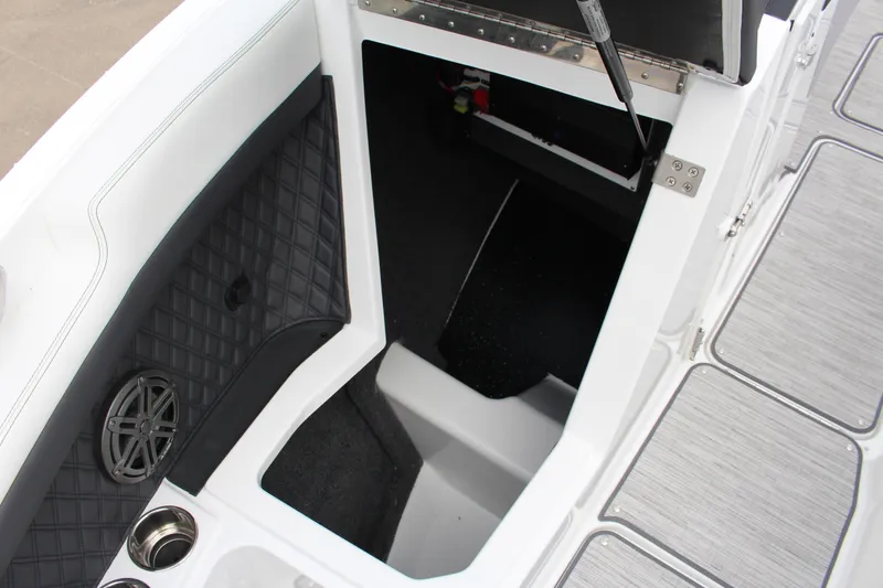 Slide: The Image of 2025 Cobalt R6 boat interior storage compartment with speaker and cup holder. - 18