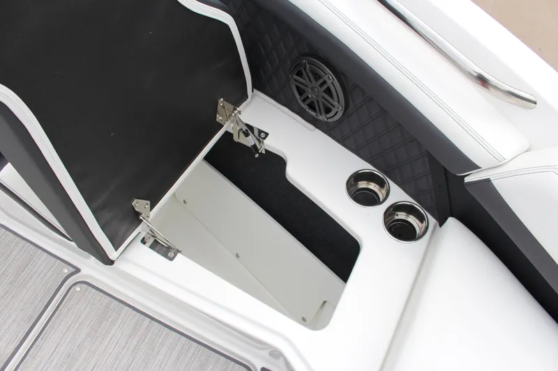 Slide: The Image of 2025 Cobalt R6 boat interior with open storage, cup holders, and speaker detail. - 19
