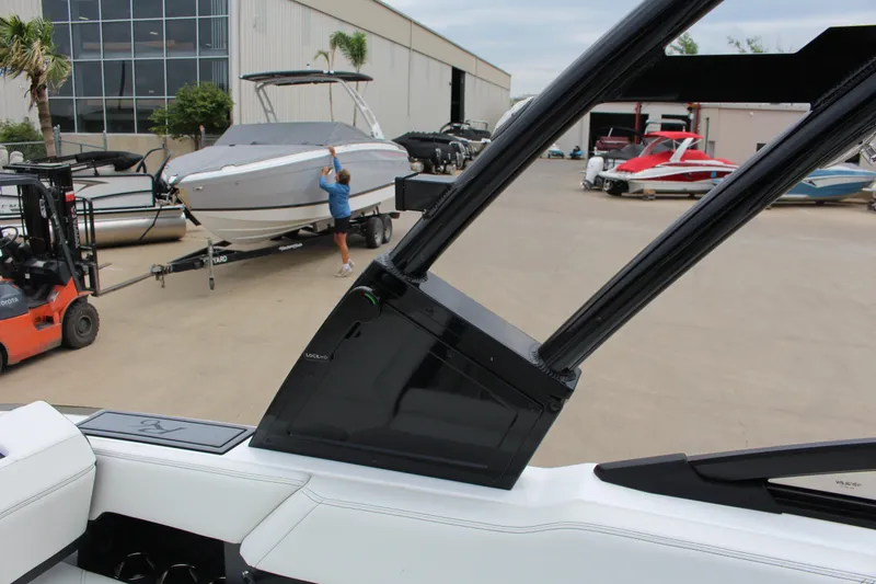 Slide: The Image of 2025 Cobalt R6 boat in marina with forklift and other boats in background. - 27