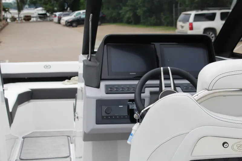 Slide: The Image of 2025 Cobalt R6 boat cockpit with modern steering and dual screens. - 29