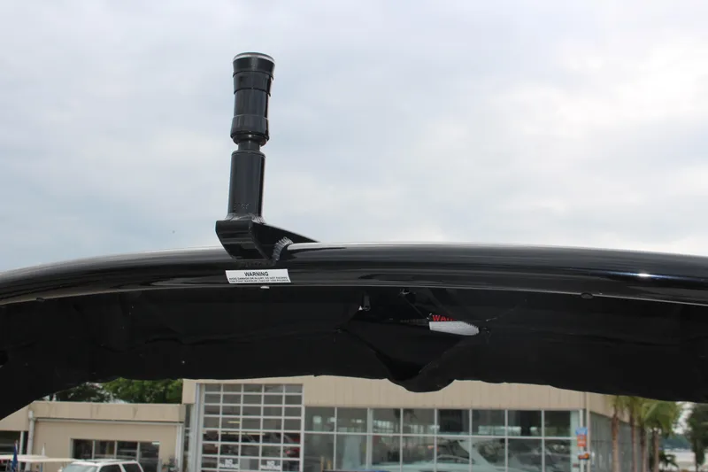 Slide: The Image of 2025 Cobalt R6 boat with a black radar arch against a cloudy sky. - 32