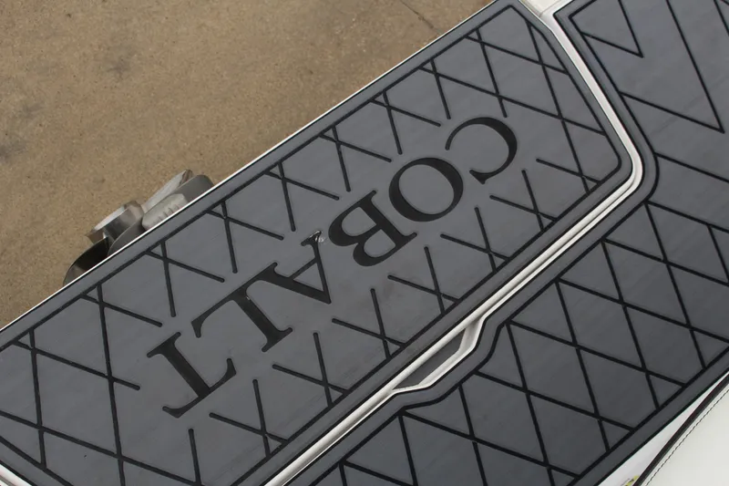 Slide: The Image of 2025 Cobalt R6 boat deck with textured pattern and logo. - 34