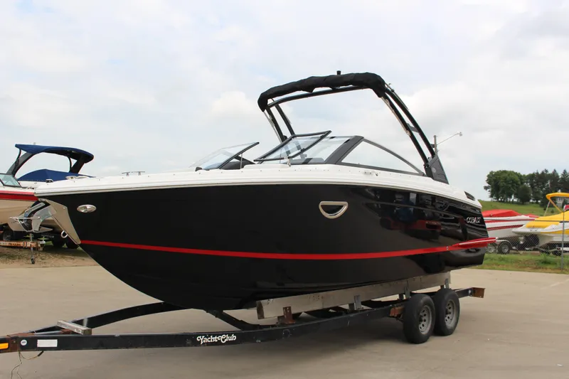 Slide: The Image of 2025 Cobalt R6 boat on trailer, black with red stripe, parked outdoors. - 39