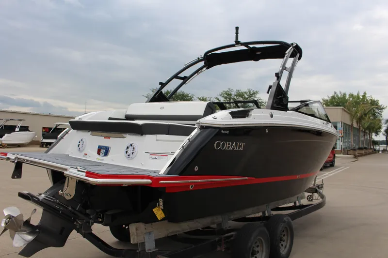 Slide: The Image of 2025 Cobalt R6 boat on trailer, sleek black design with red accents. - 5