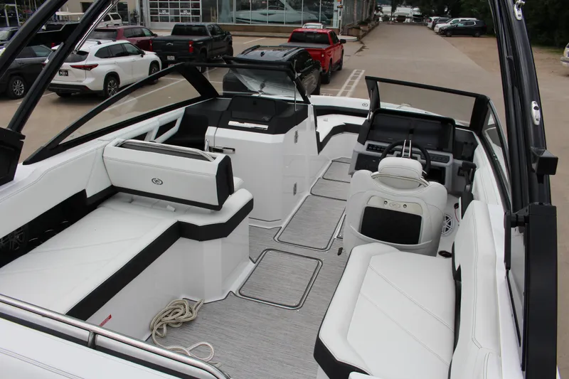 Slide: The Image of 2025 Cobalt R6 boat interior with sleek white seating and modern dashboard design. - 9