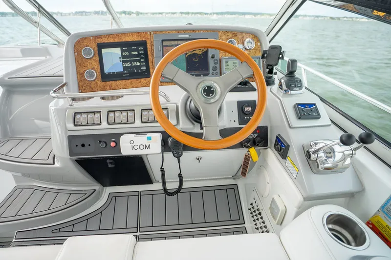 Slide: The Image of 2008 Formula 40 Performance Cruiser helm with wood steering wheel and modern navigation instruments. - 22