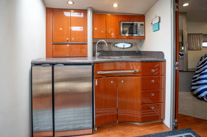 Slide: The Image of 2008 Formula 40 Performance Cruiser kitchen with wood cabinetry, stainless appliances, and modern fixtures. - 28