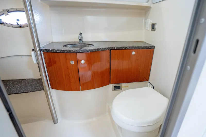 Slide: The Image of 2008 Formula 40 Performance Cruiser bathroom with sink, wooden cabinets, and toilet. - 32
