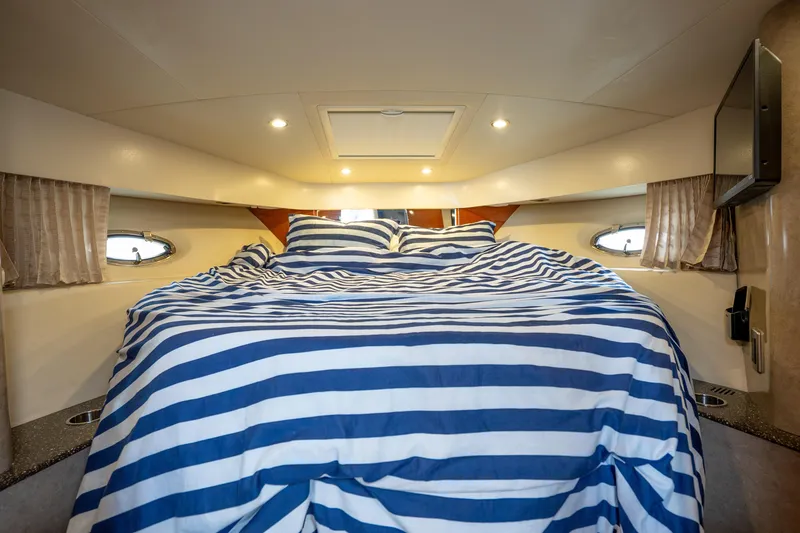Slide: The Image of Interior of 2008 Formula 40 Performance Cruiser with striped bedding and cozy lighting. - 35