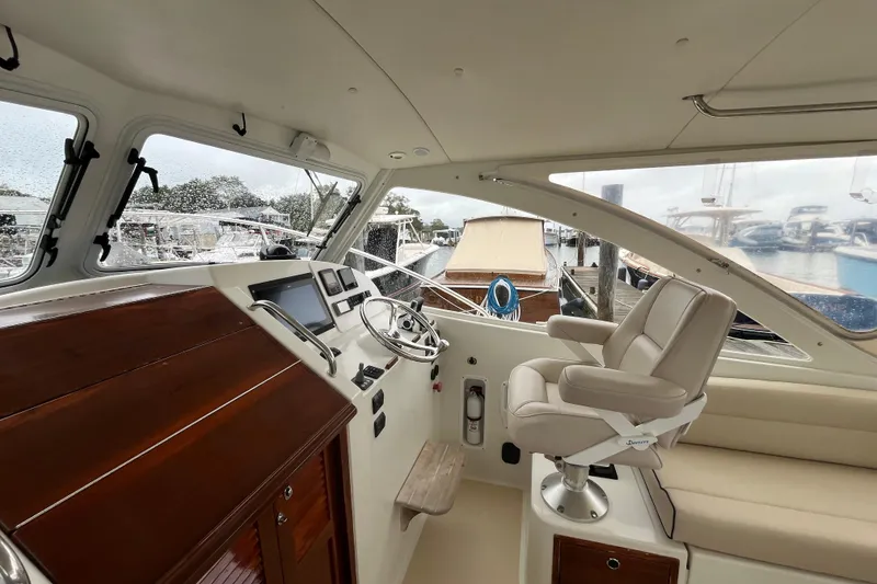 Slide: The Image of 2009 MJM 29z Express boat interior with helm, steering wheel, and captain's chair. - 10