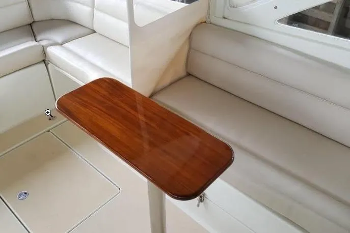 Slide: The Image of Interior of 2009 MJM 29z Express with sleek wooden table and cushioned seating. - 14