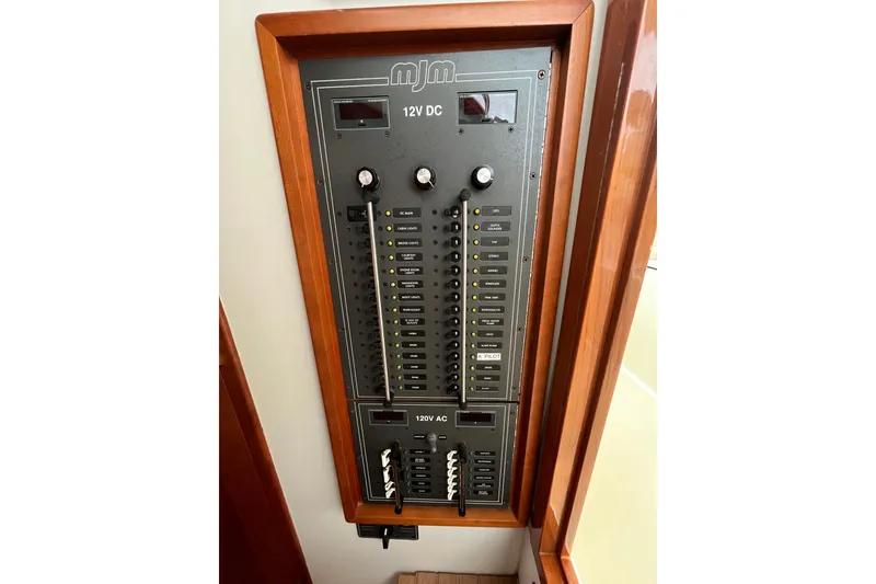Slide: The Image of Electrical panel of 2009 MJM 29z Express boat with 12V DC and 120V AC controls. - 16