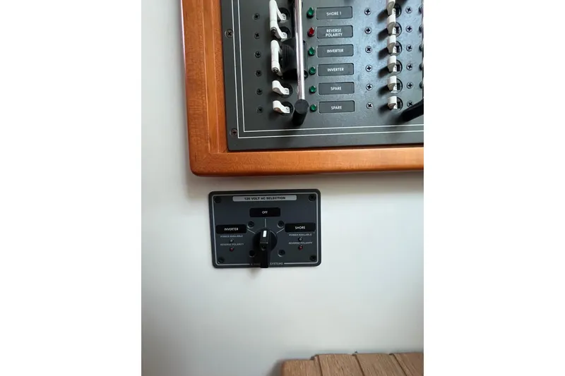 Slide: The Image of Electrical panel on a 2009 MJM 29z Express boat, featuring switches and controls. - 17