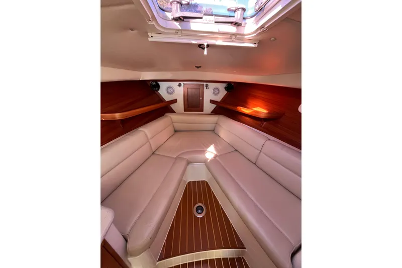 Slide: The Image of 2009 MJM 29z Express cabin interior with beige seating and wooden accents. - 22