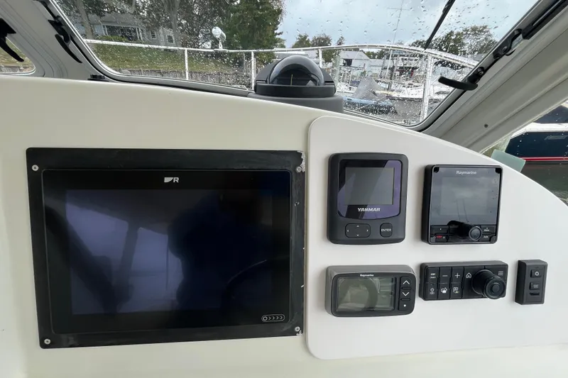 Slide: The Image of Dashboard of a 2009 MJM 29z Express boat with navigation and control instruments. - 6