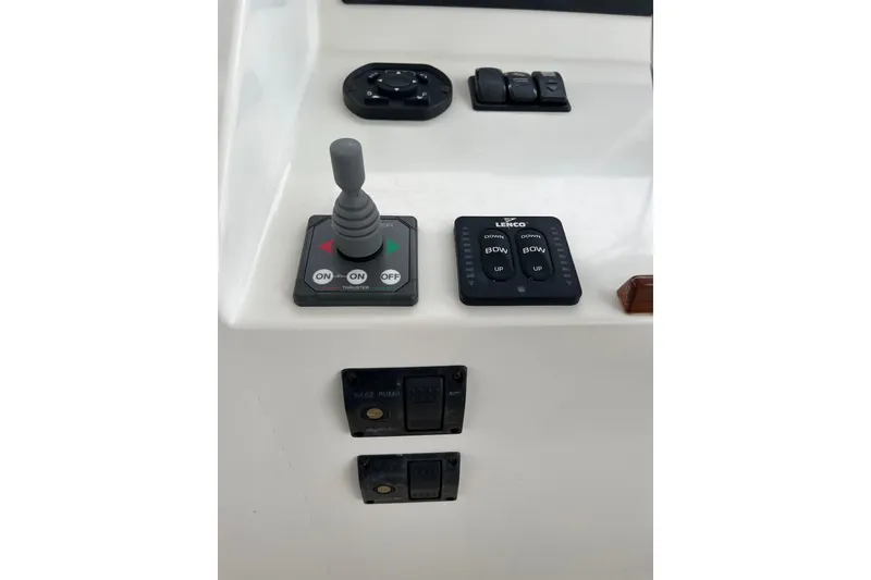 Slide: The Image of Control panel of a 2009 MJM 29z Express boat with joystick and switches. - 7