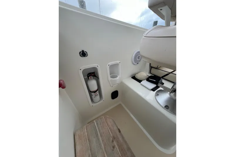 Slide: The Image of Interior of 2009 MJM 29z Express boat with fire extinguisher and seating area. - 9