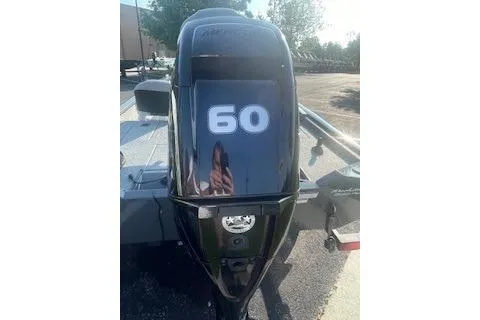 Slide: The Image of 2017 Tracker Pro Team 175 TF boat engine with "60" label, outdoors. - 10