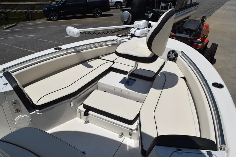 Slide: The Image of 2021 Stingray 236CC boat interior with cushioned seating and steering console. - 10