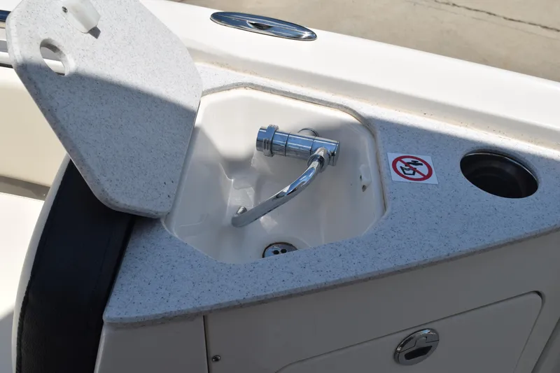 Slide: The Image of 2021 Stingray 236CC boat sink with faucet and storage compartment. - 15