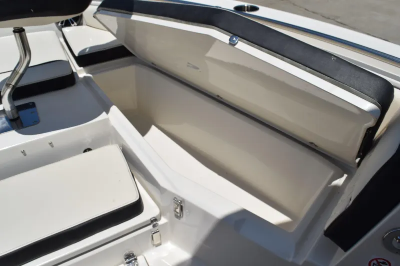 Slide: The Image of 2021 Stingray 236CC boat interior storage compartment with open lid. - 18