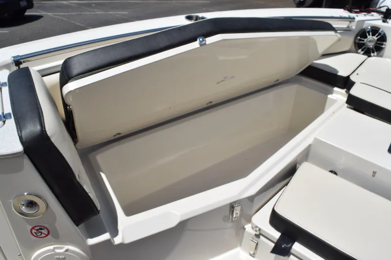 Slide: The Image of 2021 Stingray 236CC boat with open storage compartment and cushioned seating. - 19