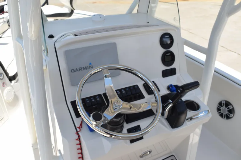 Slide: The Image of 2021 Stingray 236CC boat dashboard with Garmin navigation system and steering wheel. - 21