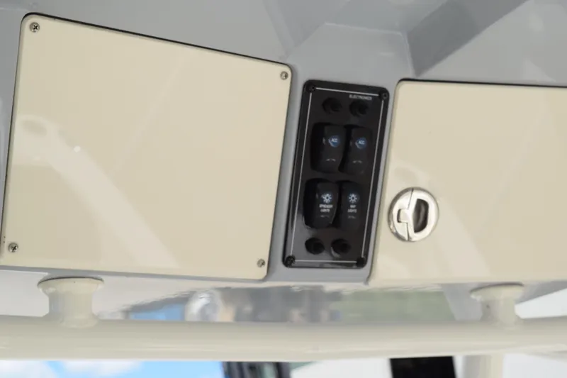 Slide: The Image of Control panel on 2021 Stingray 236CC boat, featuring switches and storage compartment. - 22