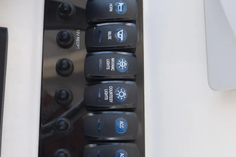 Slide: The Image of Control panel of a 2021 Stingray 236CC boat with labeled switches for various functions. - 23