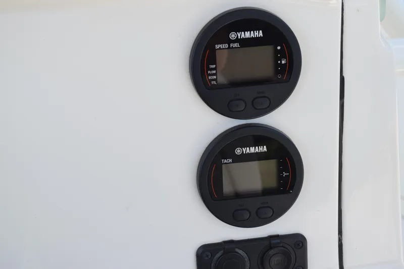 Slide: The Image of Yamaha gauges on 2021 Stingray 236CC boat dashboard, displaying speed, fuel, and tachometer. - 25